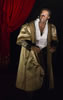 Aldridge playing Othello in gold cloak, ruffled shirt and black pants with a red velvet curtain pulled back behined his right shoulder